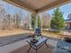 Relaxing covered patio featuring outdoor seating and a view of the backyard and landscaping at 4856 Pepper Dr, Harrisburg, NC 28075