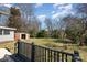 View of backyard featuring a shed and mature trees, captured from the home's deck at 520 Rogers St, Albemarle, NC 28001