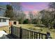 View of backyard featuring a shed and mature trees, captured from the home's deck at 520 Rogers St, Albemarle, NC 28001