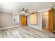 Spacious bedroom features light gray walls, wood-look floors, and a sliding wood door at 520 Rogers St, Albemarle, NC 28001