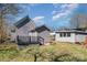 Backyard featuring a fenced-in yard with a wooden deck, shed, and horizontal siding on the house at 520 Rogers St, Albemarle, NC 28001