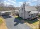 Charming home boasts a gravel driveway leading to the covered carport and a welcoming porch at 520 Rogers St, Albemarle, NC 28001