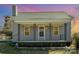 Charming home featuring a cozy front porch with decorative iron railings and landscaped garden, perfect for relaxing evenings at 520 Rogers St, Albemarle, NC 28001
