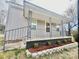 Charming covered front porch with decorative railings and fresh landscaping welcomes you home at 520 Rogers St, Albemarle, NC 28001