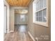 Hallway with wood-look floors, light gray walls, and a striking wood plank ceiling at 520 Rogers St, Albemarle, NC 28001