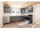 Well-equipped kitchen with gray cabinetry, stainless steel appliances, and wood-look flooring at 520 Rogers St, Albemarle, NC 28001