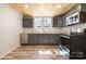 Updated kitchen with gray cabinets, stainless steel appliances, and wood-look flooring at 520 Rogers St, Albemarle, NC 28001
