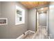 Laundry room with light gray walls, wood-look floors, and a sliding barn wood closet door at 520 Rogers St, Albemarle, NC 28001