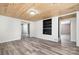 Spacious living room with wood-look floors, modern paint, and built-in shelving at 520 Rogers St, Albemarle, NC 28001