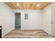 Room with light gray walls, wood-look floors, and a striking wood plank ceiling at 520 Rogers St, Albemarle, NC 28001