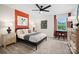 Cozy bedroom featuring an accent wall, modern furnishings, and a window with a view of the outdoors at 5220 Hatcher Creek Rd # 56, Charlotte, NC 28215