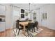 Well-lit dining room featuring a modern light fixture, wood floors, and decoratively-appointed sideboard at 5220 Hatcher Creek Rd # 56, Charlotte, NC 28215