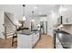 Bright, well-lit kitchen with an island, stainless appliances, and modern finishes at 5220 Hatcher Creek Rd # 56, Charlotte, NC 28215