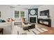 Cozy living room with a fireplace, large windows, and stylish decor at 5220 Hatcher Creek Rd # 56, Charlotte, NC 28215