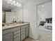 Bright bathroom featuring a double sink vanity with granite countertop and view to the main bedroom at 5227 Hatcher Creek Rd # 43, Charlotte, NC 28215