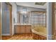 Bright bathroom featuring double vanity, a soaking tub with glass enclosure, and decorative accents at 524 Damascus Church Rd, Statesville, NC 28625