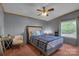 Cozy bedroom featuring a bed, ceiling fan, a window with natural light, and coordinated decor at 524 Damascus Church Rd, Statesville, NC 28625
