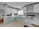 Well-lit kitchen area featuring white cabinets and appliances, with a view into the dining room at 524 Damascus Church Rd, Statesville, NC 28625