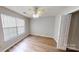 Neutral bedroom with a ceiling fan and natural light at 5921 Amity Springs Dr, Charlotte, NC 28212