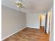 Bedroom featuring hardwood floors, a ceiling fan, and access to hallway at 5921 Amity Springs Dr, Charlotte, NC 28212
