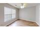 This bedroom has wood floors, ceiling fan, and a large window for natural light at 5921 Amity Springs Dr, Charlotte, NC 28212