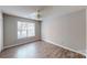 Cozy bedroom with a ceiling fan and natural light from a large window at 5921 Amity Springs Dr, Charlotte, NC 28212