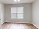 A bedroom with wood floors, a ceiling fan, and a large window for plenty of natural light at 5921 Amity Springs Dr, Charlotte, NC 28212