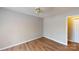 A cozy bedroom featuring hardwood flooring and a ceiling fan for comfort at 5921 Amity Springs Dr, Charlotte, NC 28212