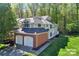 Two-story home features attached two-car garage, and a landscaped yard on a wooded lot at 5921 Amity Springs Dr, Charlotte, NC 28212
