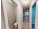 Inviting hallway leads to a powder room and a living area with lots of natural light at 5921 Amity Springs Dr, Charlotte, NC 28212