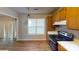 Cozy kitchen with stainless steel appliances, wood cabinets, and laminate flooring at 5921 Amity Springs Dr, Charlotte, NC 28212