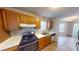 Traditional kitchen features wood cabinets, laminate countertop and stainless steel range at 5921 Amity Springs Dr, Charlotte, NC 28212