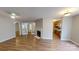 Bright living room with laminate floors, a fireplace, and glass doors leading to another room at 5921 Amity Springs Dr, Charlotte, NC 28212