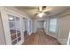 Versatile room features wood-look laminate flooring and glass French doors at 5921 Amity Springs Dr, Charlotte, NC 28212