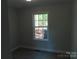 Bedroom featuring a large window that provides plenty of natural light, neutral walls, and modern flooring at 635 Acre Ct, York, SC 29745