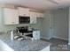 Well-equipped kitchen with granite countertops, stainless steel appliances, and sleek white cabinetry at 635 Acre Ct, York, SC 29745