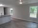 Living room featuring modern flooring, neutral paint, granite countertops, and natural light from two windows at 635 Acre Ct, York, SC 29745