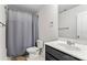 Clean bathroom featuring a vanity sink, toilet, and a shower with a gray shower curtain at 7512 Spring Spruce Ln, Charlotte, NC 28227