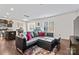 Open concept living room and kitchen with modern decor, dark wood floors, and an aquarium at 7512 Spring Spruce Ln, Charlotte, NC 28227