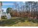 View of backyard with trees and stair access to deck at 8025 Penman Springs Dr, Waxhaw, NC 28173