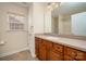 Bathroom featuring wood cabinets, light countertops, and a sink at 8025 Penman Springs Dr, Waxhaw, NC 28173