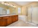 Bathroom includes double vanity, bathtub, and glass shower at 8025 Penman Springs Dr, Waxhaw, NC 28173