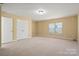 Bright bedroom with neutral carpet, large closet and natural light from a window at 8025 Penman Springs Dr, Waxhaw, NC 28173