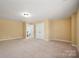 Spacious bedroom featuring neutral carpet, a double closet and an open doorway at 8025 Penman Springs Dr, Waxhaw, NC 28173