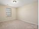 Neutral bedroom featuring carpet and a window with natural light at 8025 Penman Springs Dr, Waxhaw, NC 28173