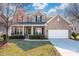 Charming brick home featuring a well-manicured front lawn and attached two-car garage, enhancing its curb appeal at 8025 Penman Springs Dr, Waxhaw, NC 28173