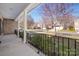View from the covered front porch overlooking a quiet, tree-lined neighborhood street at 8025 Penman Springs Dr, Waxhaw, NC 28173