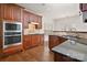 Spacious kitchen features cherry cabinets, stainless steel appliances, and granite countertops at 8025 Penman Springs Dr, Waxhaw, NC 28173