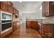 Well-lit kitchen offers cherry cabinets, stainless steel appliances, and a breakfast nook at 8025 Penman Springs Dr, Waxhaw, NC 28173