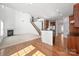 Bright living room with fireplace, open staircase and kitchen with dark wood cabinets at 8025 Penman Springs Dr, Waxhaw, NC 28173